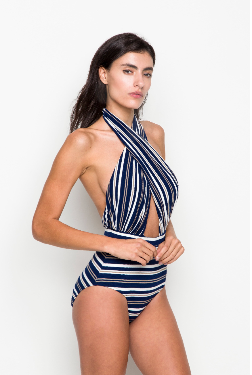 Woman wearing 6 Shore Road Cabana One Piece Swimsuit with keyhole detail, standing poolside in Italian-inspired swimwear